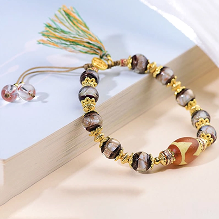 Nine-eye dzi bead bracelet detail shot highlighting incense ash liuli glass beads and spiritual craftsmanship