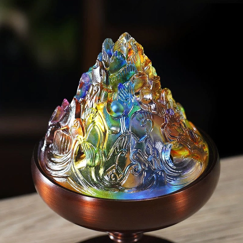 Close-up of intricately carved Liuli glass mountain lid showing detailed multicolor design and texture