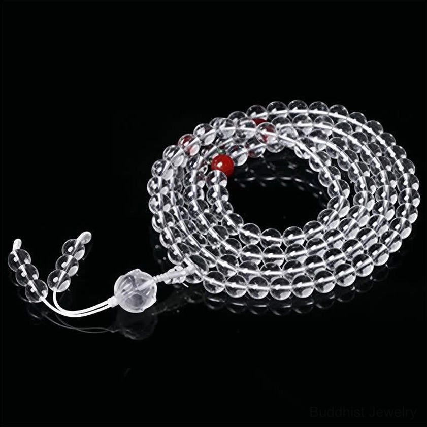 108 bead Buddhist prayer mala with red agate spacers and crystal tassel, top-down flat lay view