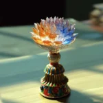 Liuli glass lotus enlightenment lamp with multicolor gradient petals and decorative enamel base on wooden table