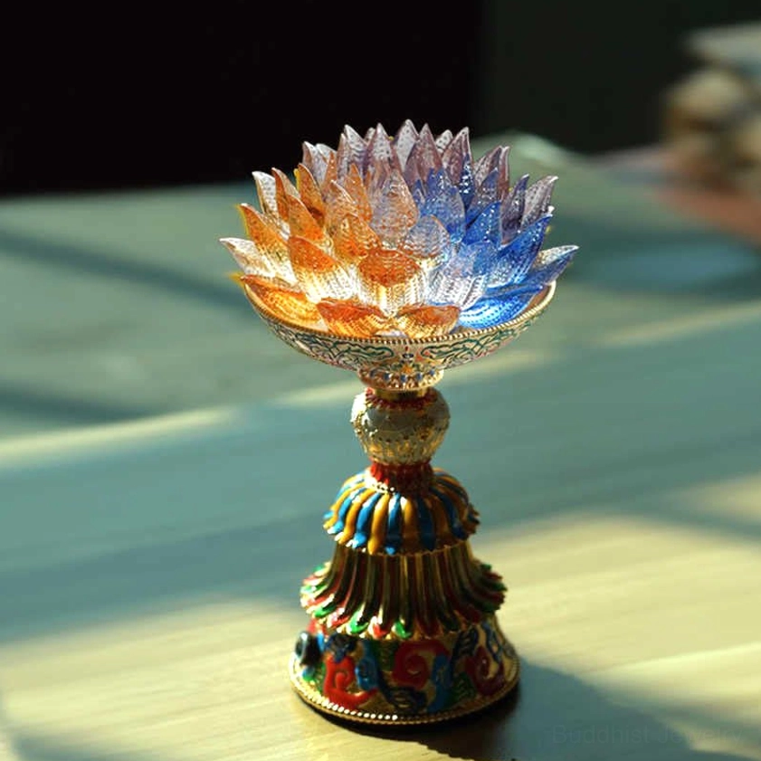Liuli glass lotus enlightenment lamp with multicolor gradient petals and decorative enamel base on wooden table