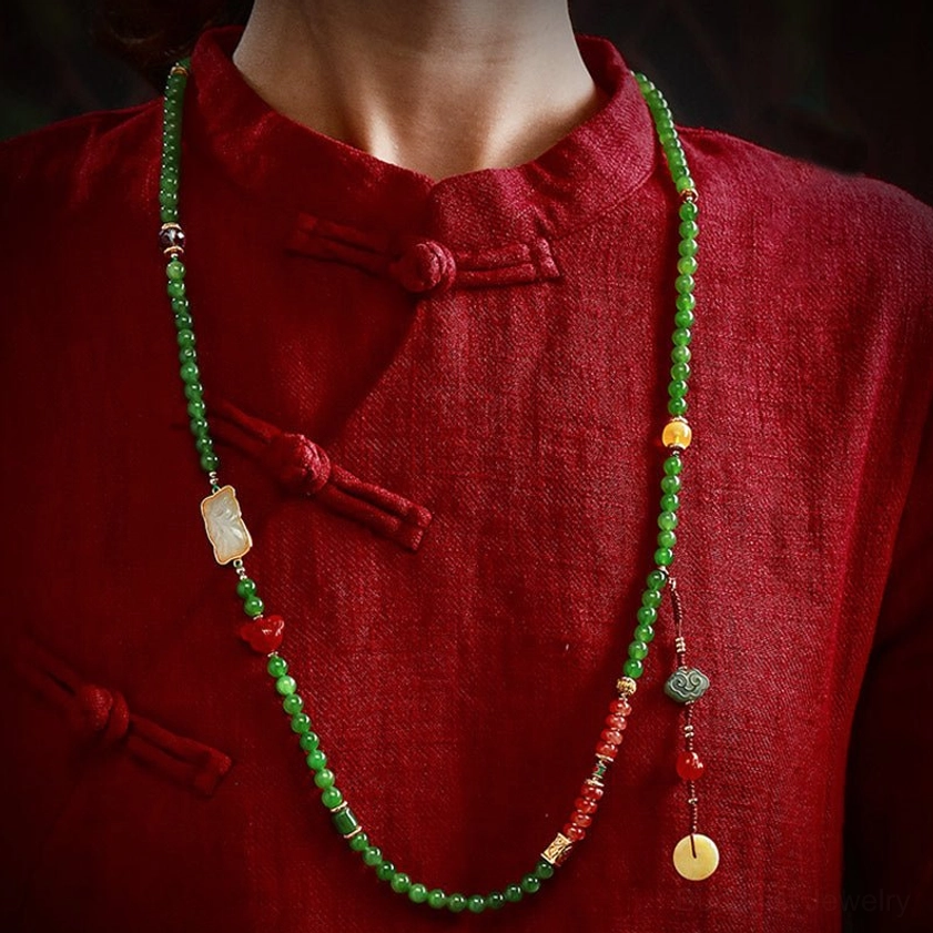 Long jade prayer necklace worn on torso with Hetian jade square pendant and yellow tassel