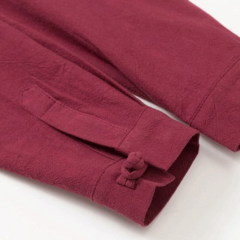 Long sleeve cuff with frog button closure on men's Buddhist meditation shirt, burgundy detail