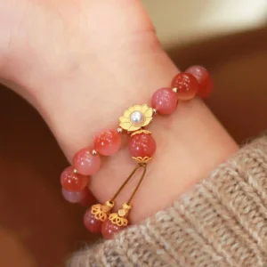 925 sterling silver lotus agate bracelet worn on wrist with gold-plated charm and pearl detail