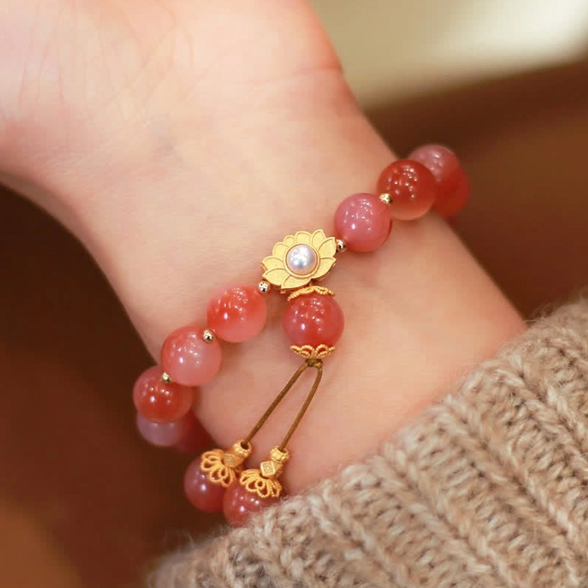925 sterling silver lotus agate bracelet worn on wrist with gold-plated charm and pearl detail