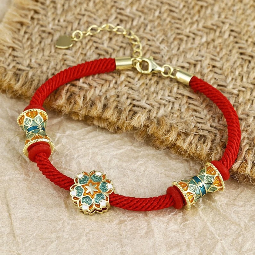 Sterling silver blessed red cord bracelet with symmetrical enamel lotus and barrel charms
