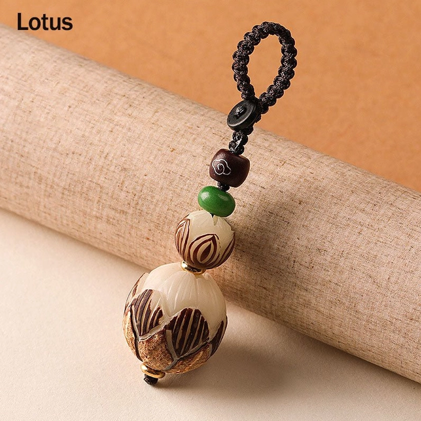 Lotus themed bodhi seed keychain with full carved lotus pendant and black braided rope