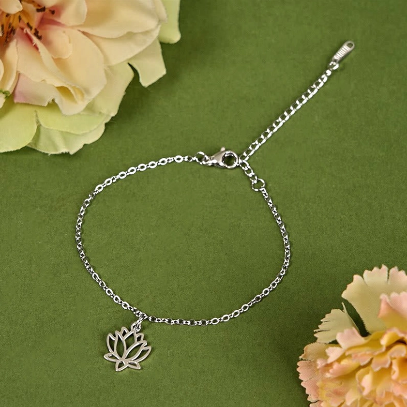 Adjustable lotus bracelet with silver chain and extender clasp on floral background