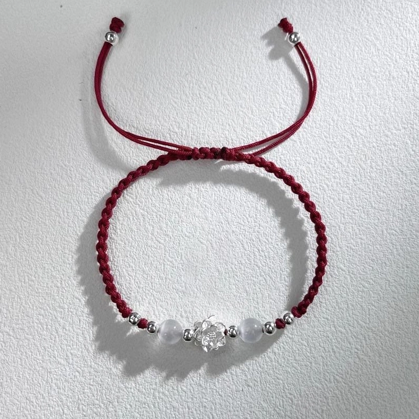 Dark red lotus protection string bracelet with silver accents handmade spiritual jewelry detail view