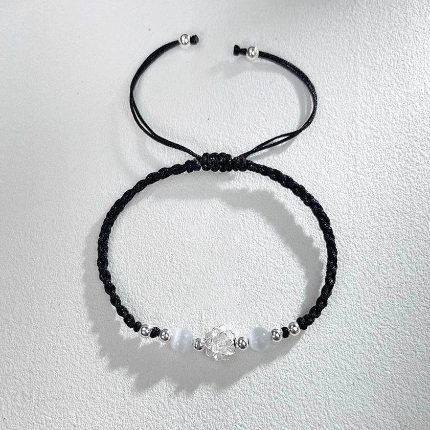 Lotus cat's eye spiritual bracelet with milky white bead and silver charm on black braided cord