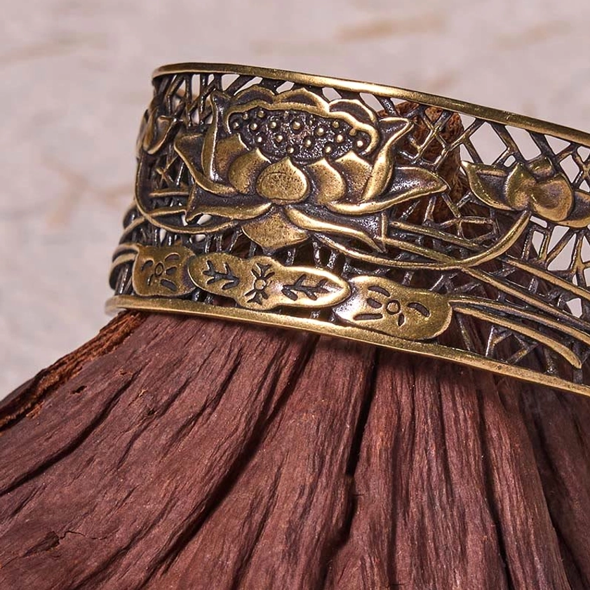 Hollow lotus spiritual open cuff bracelet pair comparison showing both silver plated copper and natural bronze finish variants side by side
