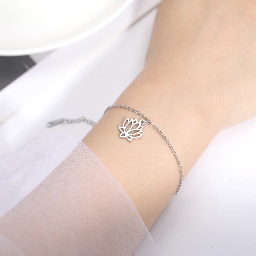 Adjustable lotus bracelet worn on wrist with smooth polished silver lotus charm