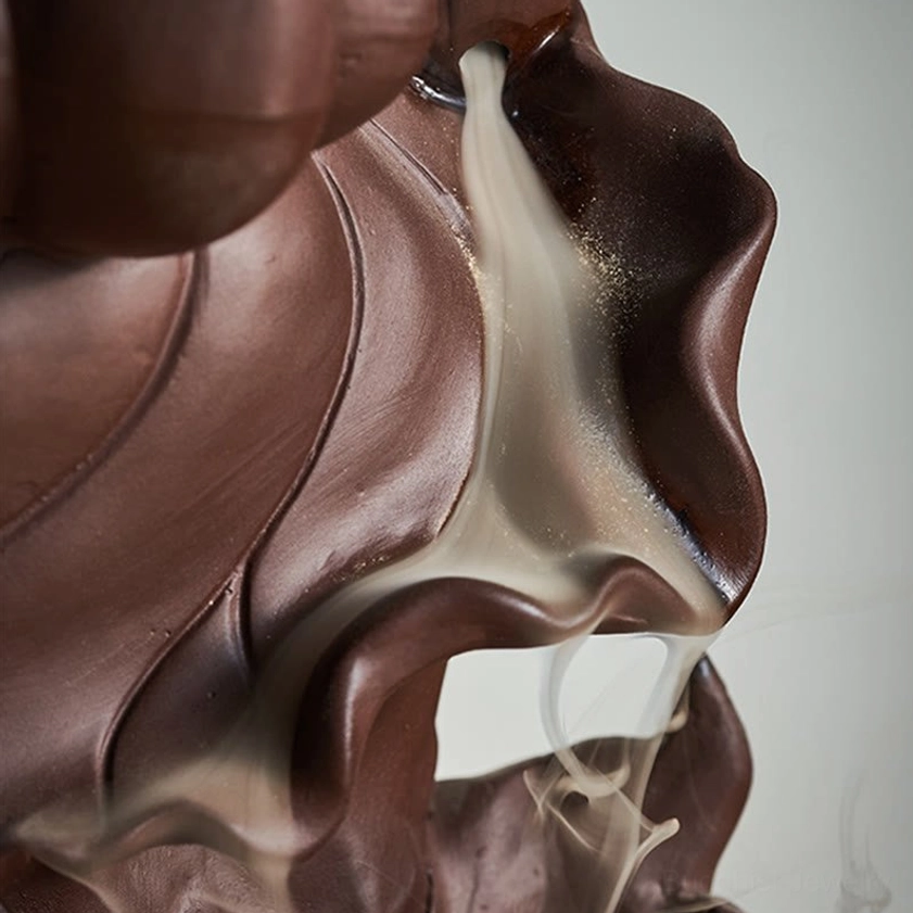 Artistic close-up of backflow incense smoke flowing downward with detailed purple clay lotus petal texture