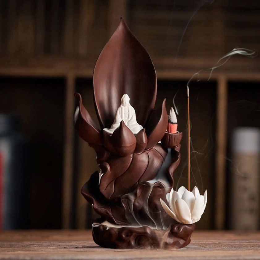 Buddhist incense burner displayed on wooden shelf with curling incense smoke and home décor styling
