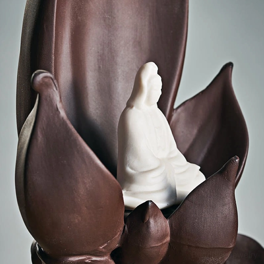 Close-up side view of Guanyin Avalokitesvara Buddha meditation figure in lotus frame with purple clay details