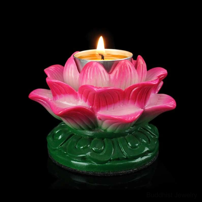 Single lotus ceramic candle holder with lit tealight in pink gradient finish, green carved base, front top close-up view on black studio background