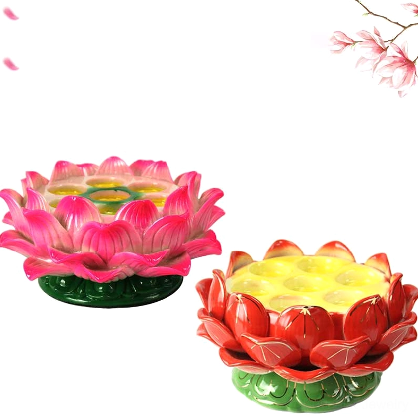 Pair of multi-cup lotus candle holders in pink and red ceramic with green bases holding multiple colored tealights, flat lay angle with flower decorations