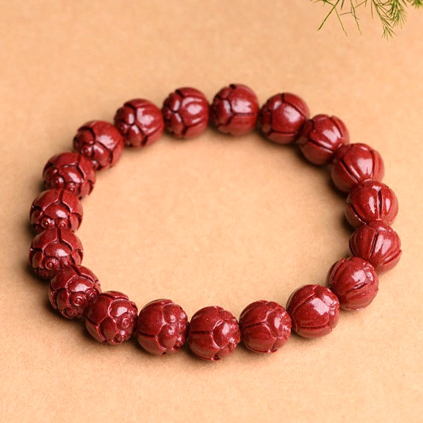 Natural cinnabar lotus pattern prayer bracelet with botanical styling showing carved lotus flowers on deep red beads