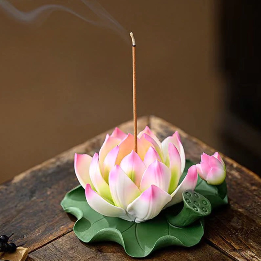 Handmade lotus ceramic incense burner with active incense stick and lotus bud detail