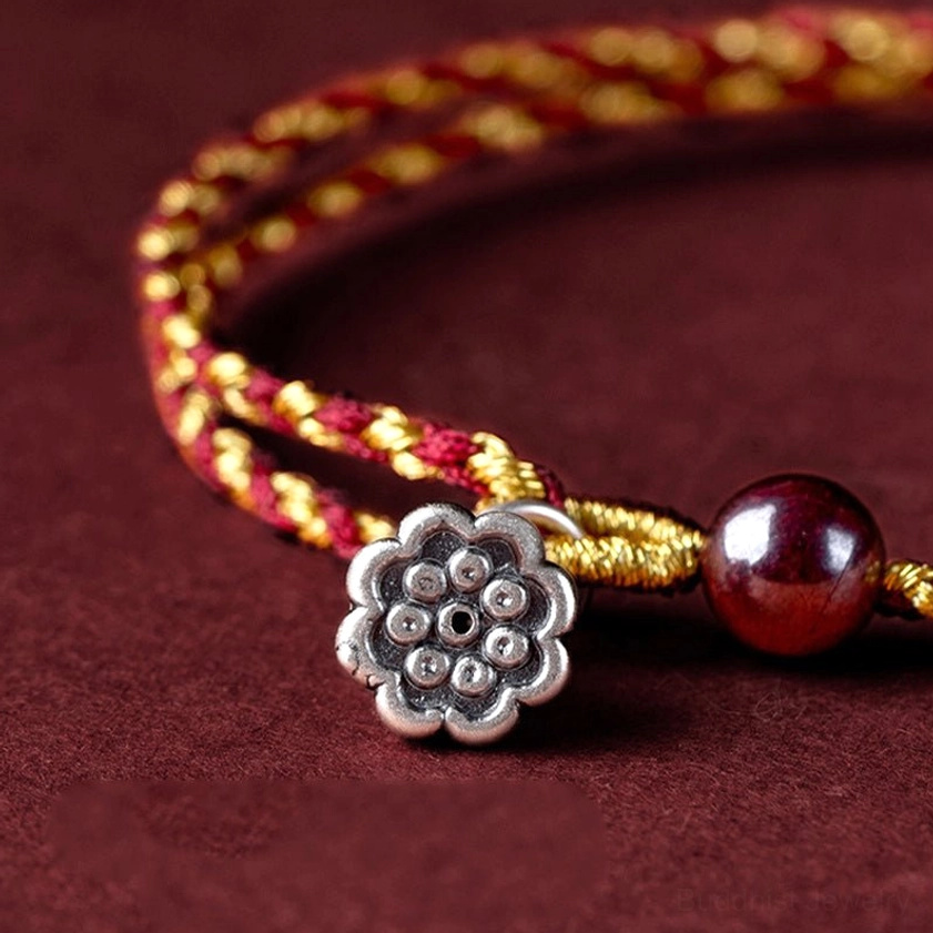 Handcrafted braided Buddhist bracelet featuring multiple lotus charm design options