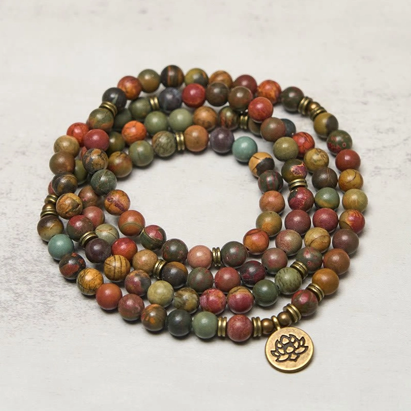 Buddhist prayer mala with brass spacer beads and lotus charm detail shot