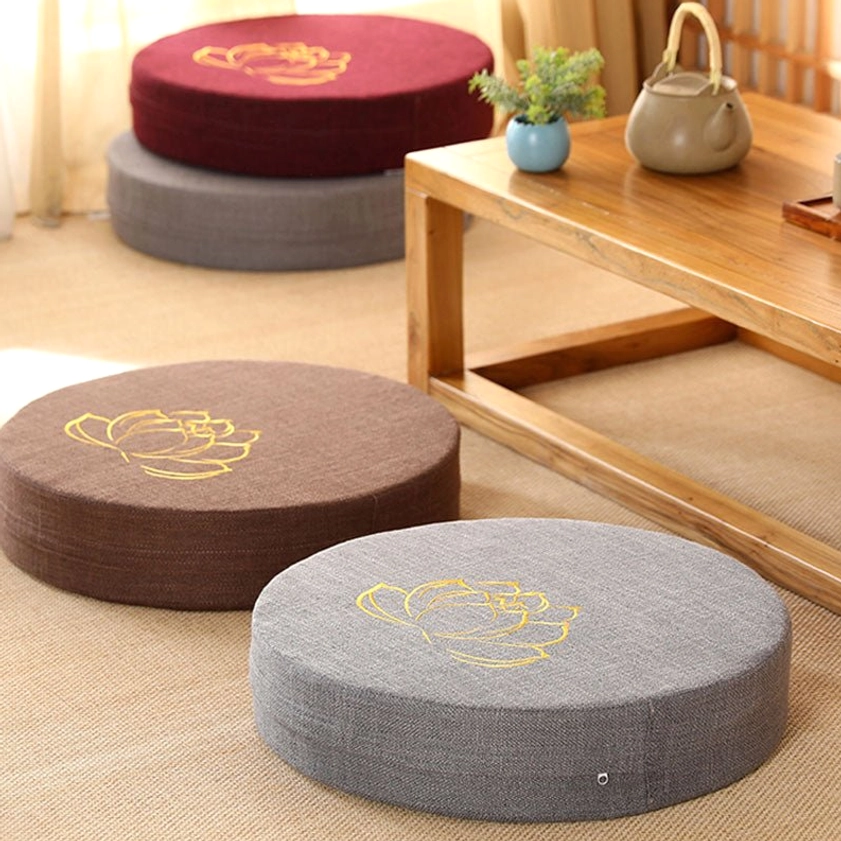 Beige and grey round meditation floor cushions eye-level perspective gold lotus embroidery linen texture