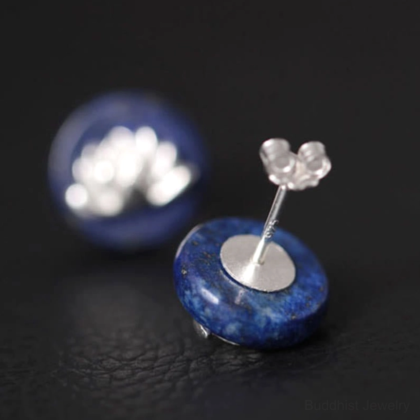 Close-up top view of single lotus stud earring with sterling silver butterfly back clasp