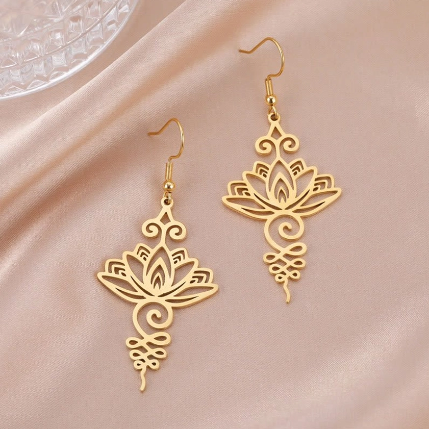 Hollow lotus flower drop earrings detailed view showing intricate filigree patterns and light reflection