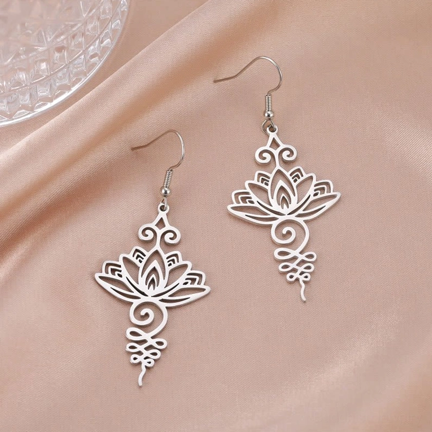 Intricate filigree lotus drop earrings silver on pink satin, delicate Buddhist symbolism jewelry