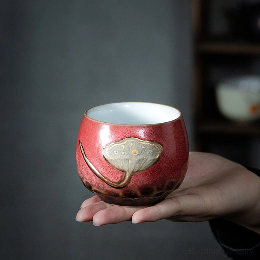 Ceramic teacup bottom rim showing dark brown mottled glaze and handcrafted artisan finish