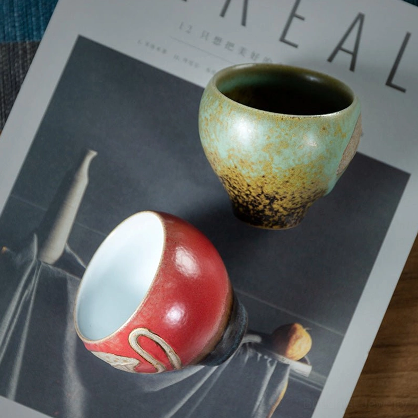 Two ceramic tea cup variants side by side, turquoise and red glazed lotus engraved designs catalog view