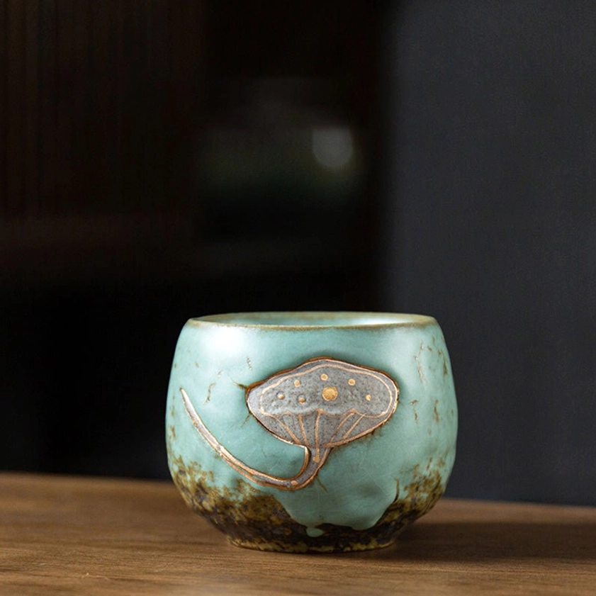 Green glazed lotus pod engraved ceramic teacup rear frontal view showing back lotus design detail