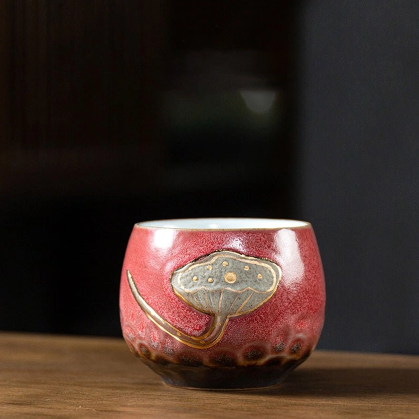 Red ceramic tea cup interior view showing matte finish and white glazed surface for tea brewing