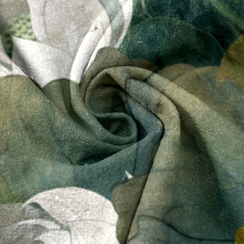 Lotus flower and leaves print swatch flat lay showing green and white botanical pattern with natural fabric drape