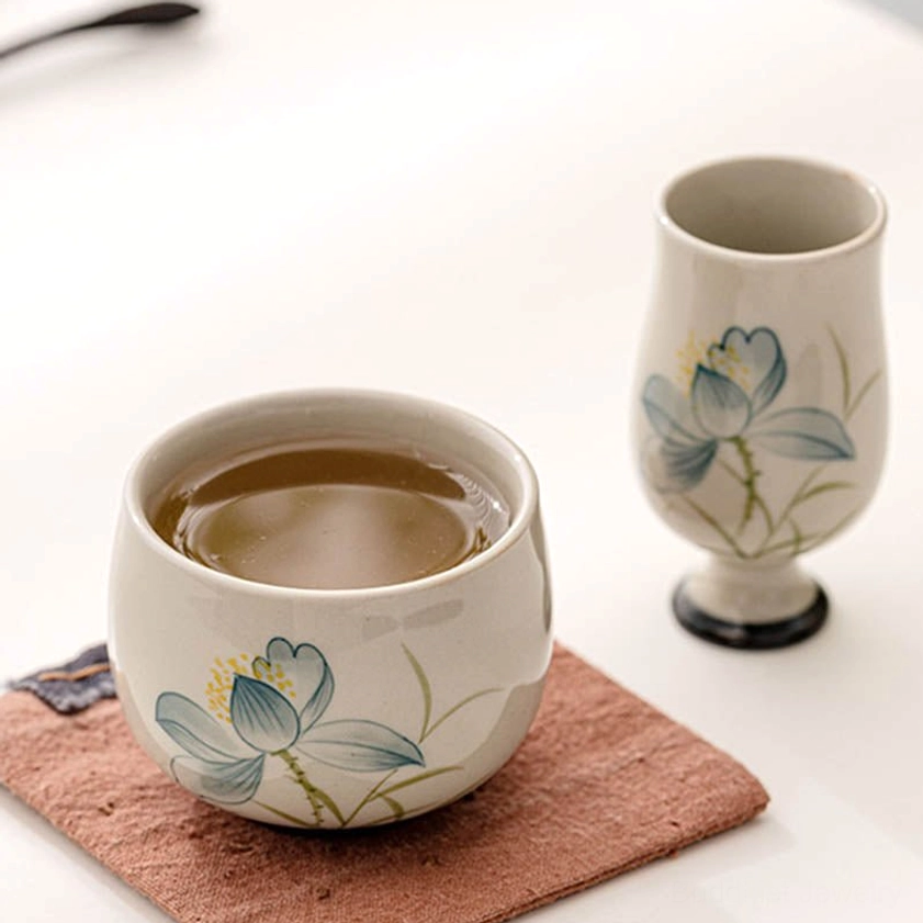 Hand-painted lotus flower tea cup with detailed blue petals for mindful tea drinking and meditation practice