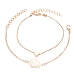 Lotus heart bracelet set flat lay showing rose gold hollow lotus charm and solid heart charm on delicate chains