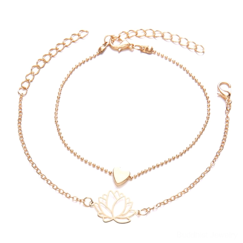 Lotus heart bracelet set flat lay showing rose gold hollow lotus charm and solid heart charm on delicate chains