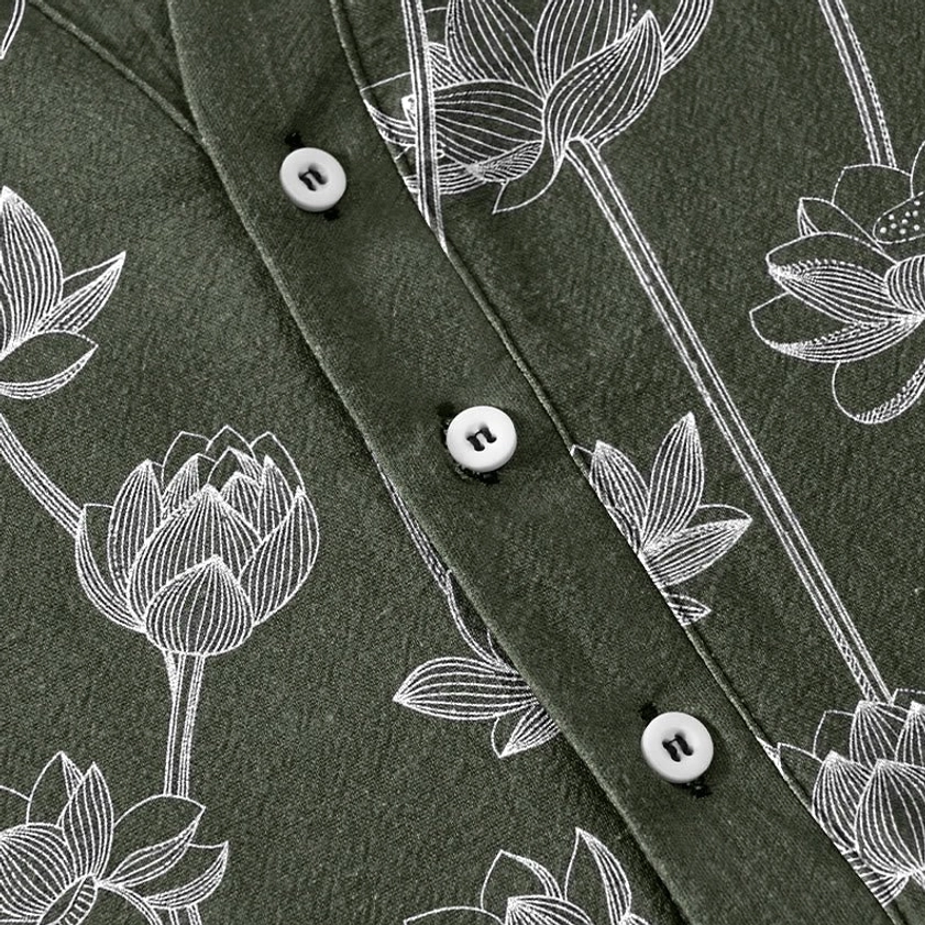 Half button placket detail on mens lotus henley showing round white buttons and intricate line art lotus flower print