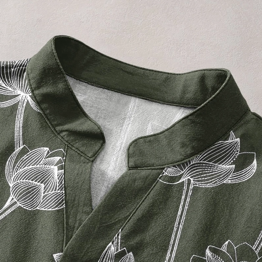 Close-up detail of stand collar on navy lotus henley shirt with white floral print and inner lining visible
