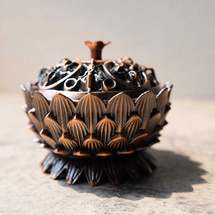 Dark bronze lotus-shaped incense burner three-quarter view showing detailed hollow carved lid and decorative finial