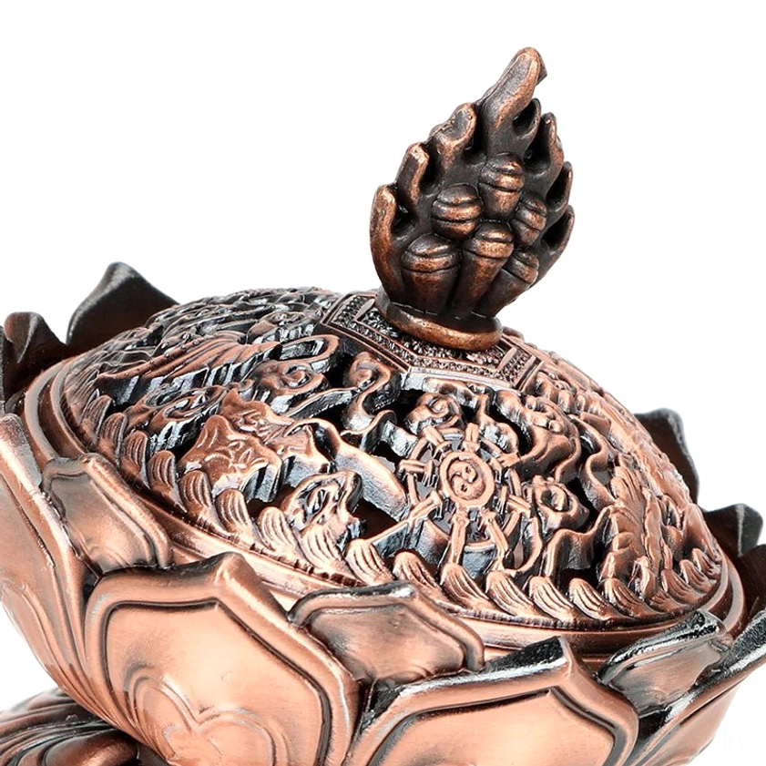 Dark copper lotus censer lid three-quarter view displaying detailed Buddhist hollow carvings and flame shaped finial for meditation