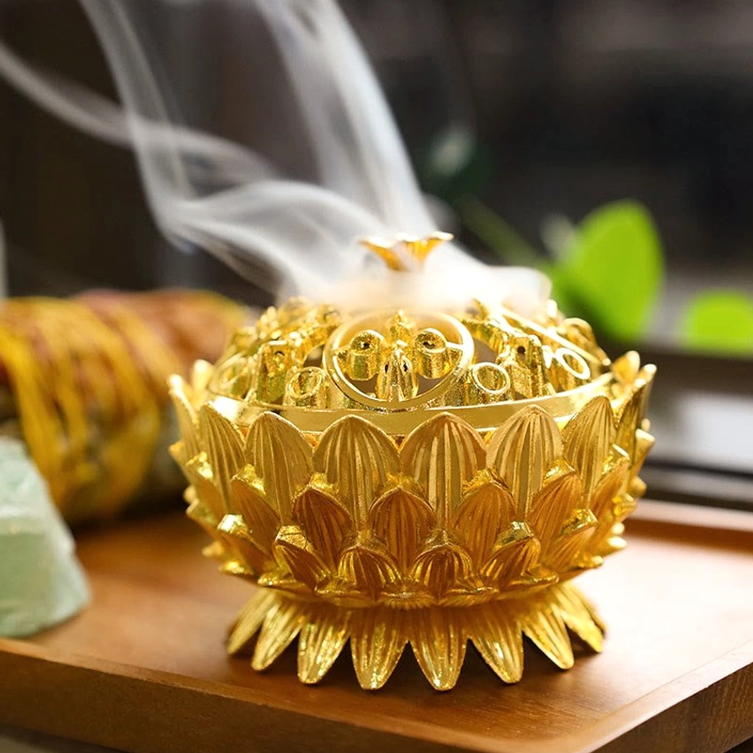 Lotus flower incense burner collection display showing multiple bronze finishes and waterfall smoke cascade effect