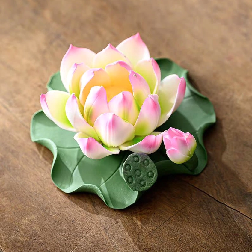 Close-up detail of lotus ceramic incense burner showing gradient pink-white lotus petals and leaf-pod base