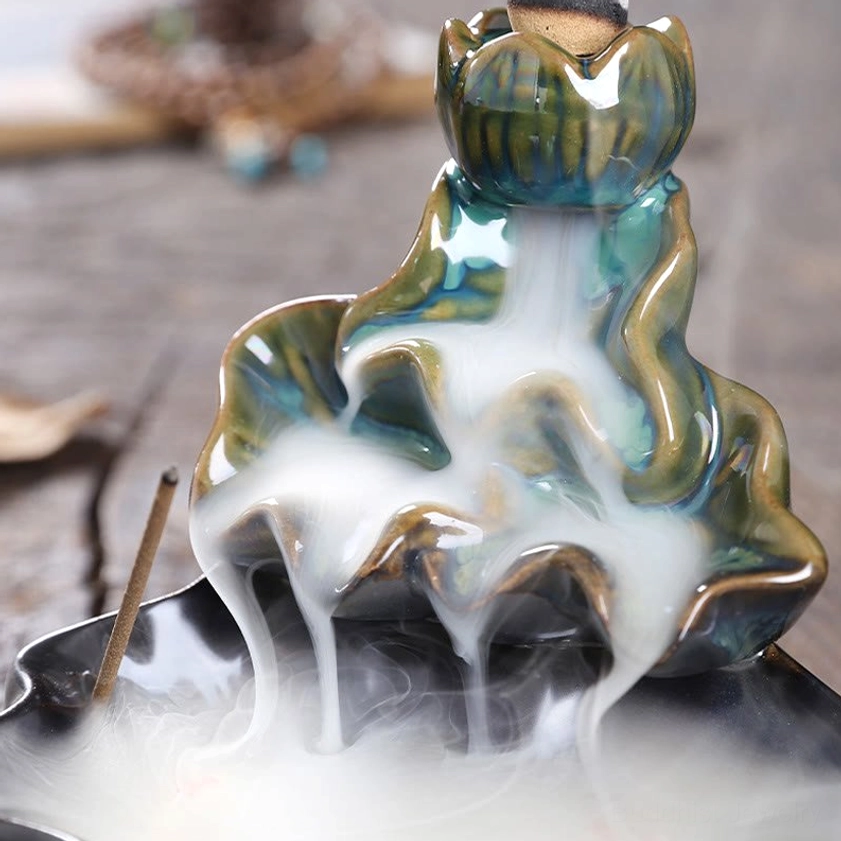 Detailed lotus ceramic structure with incense stick and smoke cascade