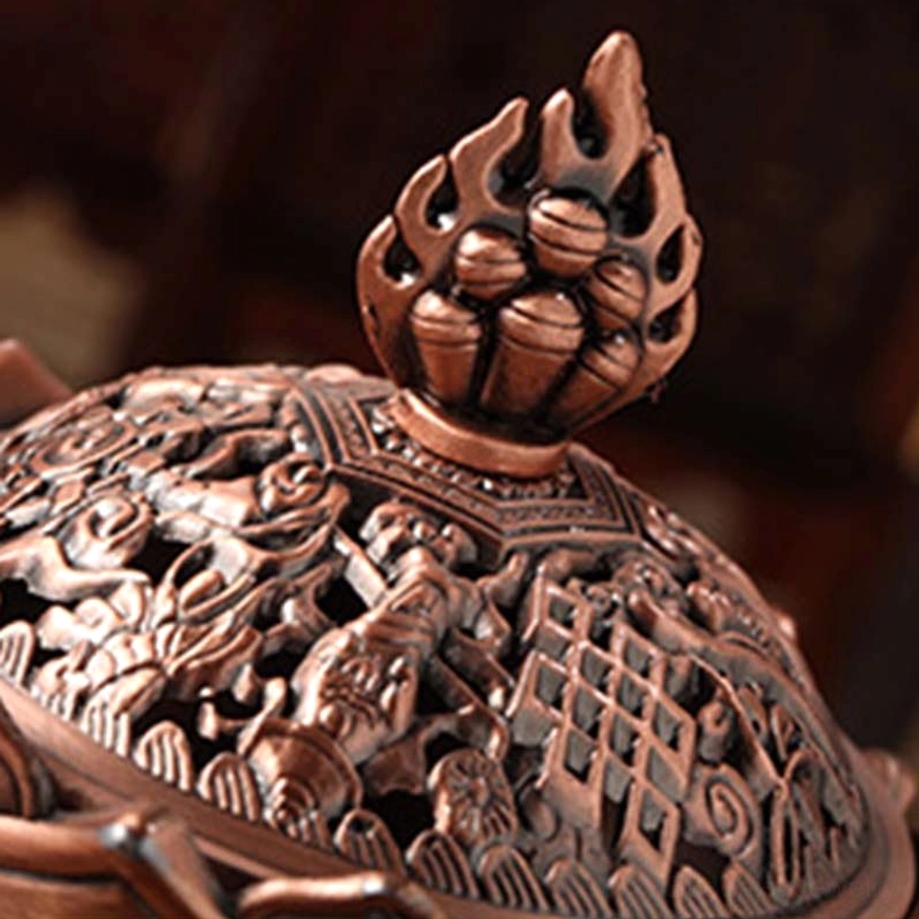 Overhead view of ornate lotus incense burner lid showing intricate flame finial and detailed carved Buddhist hollow patterns
