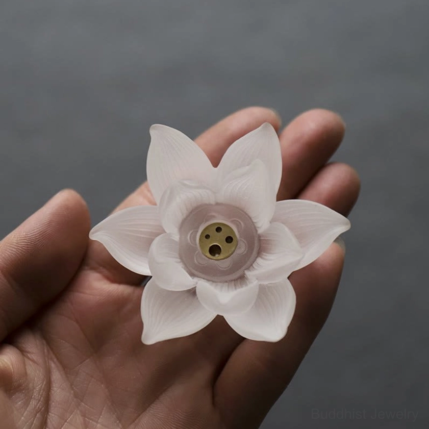 Overhead palm close-up white lotus crystal incense holder central incense hole layered petals