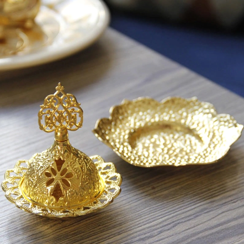 Separated lotus incense burner components including hollow carved lid and flower-shaped tray, side overhead view