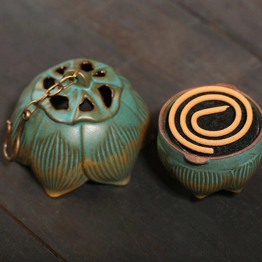Matching lotus incense burner set with green-gold design, lidded burner with chain and coil incense holder on wooden table