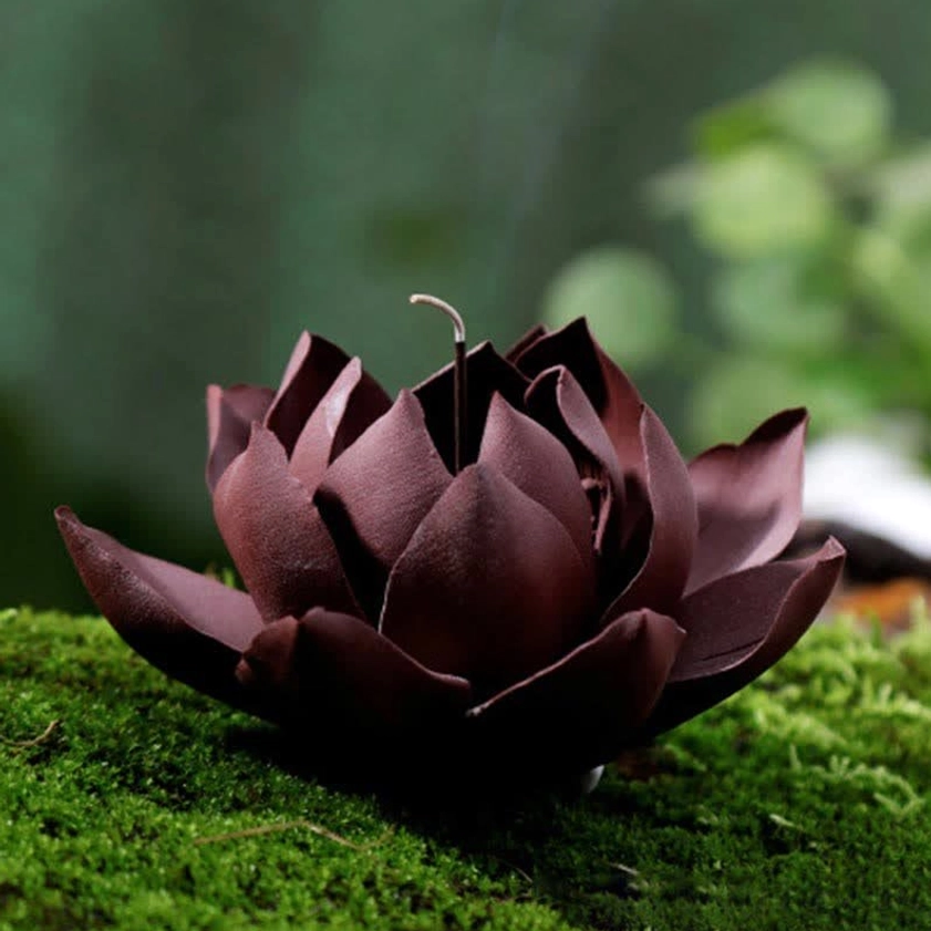 Lotus-shaped purple clay incense burner with dark maroon petals and ash-covered burning stick detail