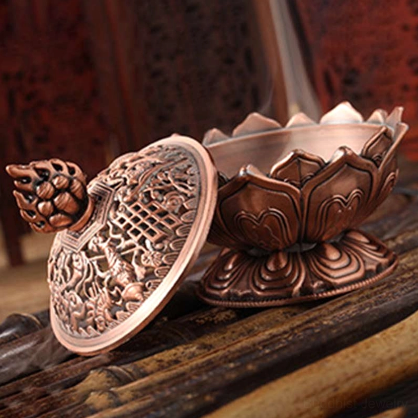 Red bronze Buddhist lotus burner side view with removable carved lid displaying lotus petal relief patterns and pedestal base